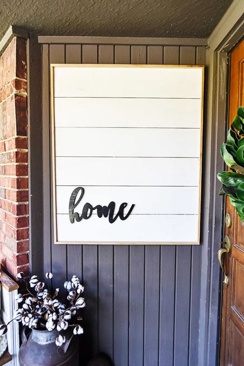 White smooth shiplap sign with frame and home word attached
