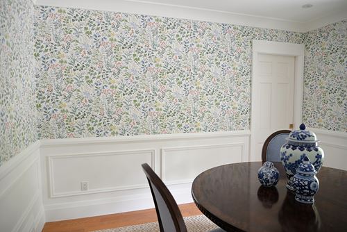 White wainscoting board and batten in dining room with floral wallpaper 