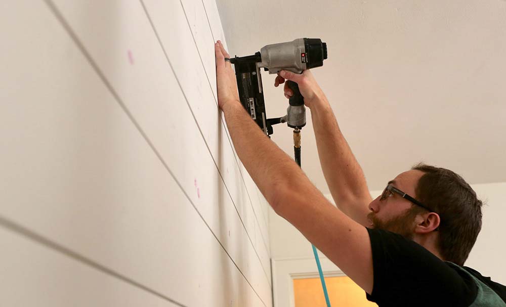 Installing shiplap using a nail gun