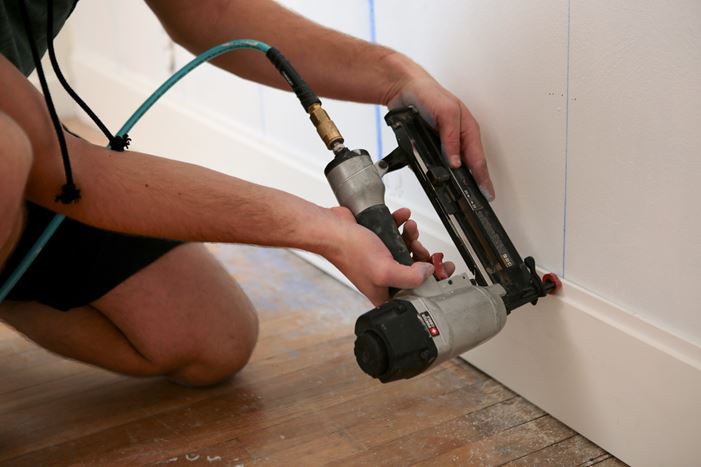 Using nail gun to board tongue