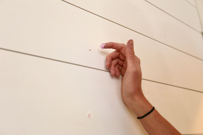 Using putty to fill in nail holes