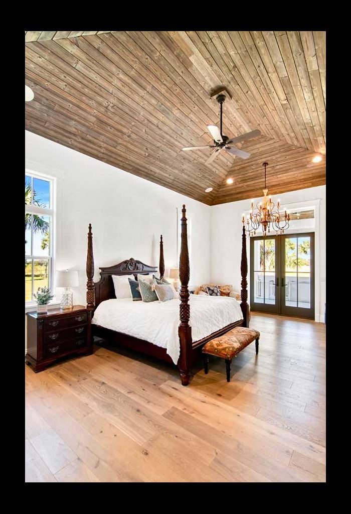 Primary bedroom with bed and vaulted ceiling featuring Charred Wood Ash Gray shiplap