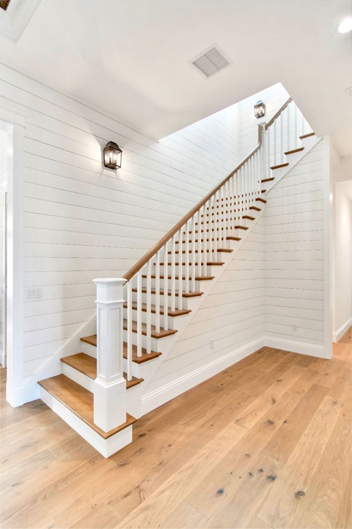 White Timeless shiplap staircase with wood floors and wood stair treads