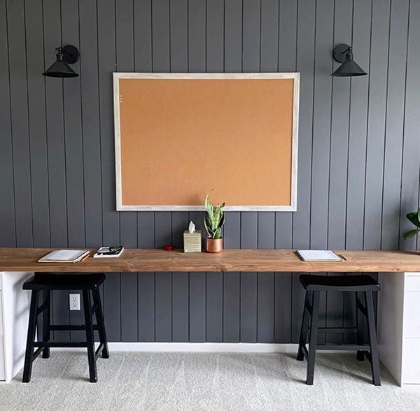Homework station room with vertical dark gray shiplap and corkboard