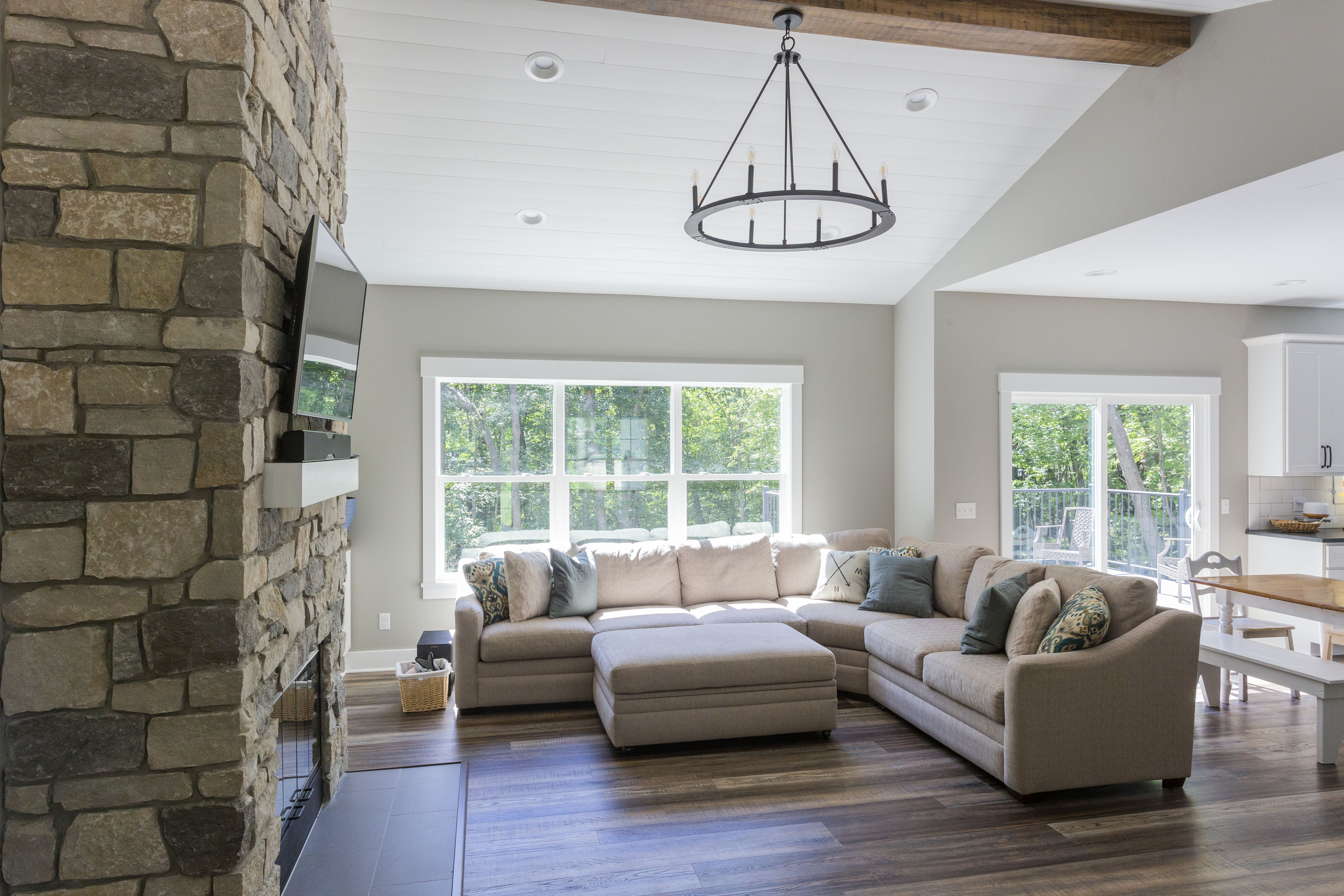 Timeless Shiplap Ceiling With Stone Fireplace in Living Room