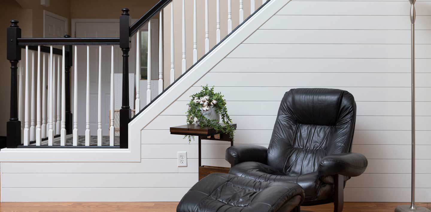 Timeless Farmhouse White shiplap staircase black recliner dark stair tread