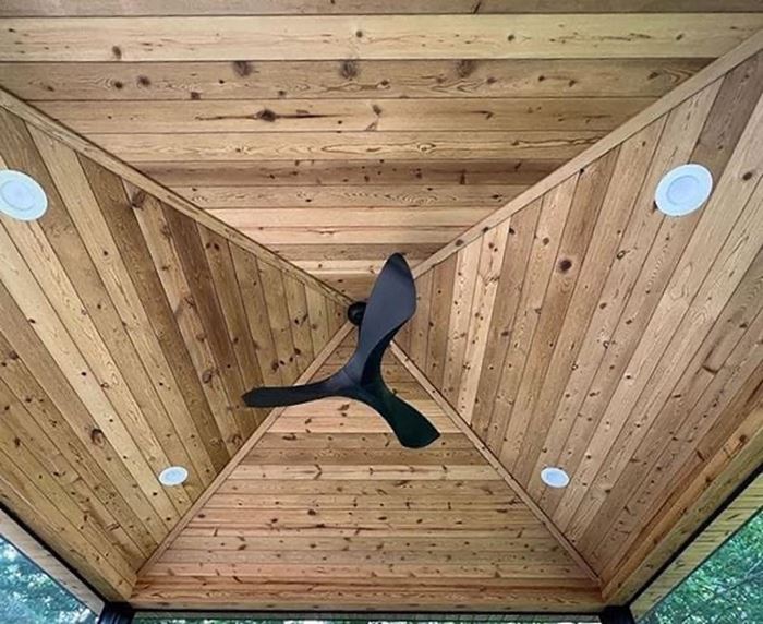 Cathedral outdoor covered porch ceiling with Thermally Modified Natural wood siding 