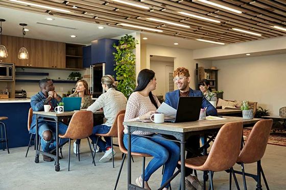 Group of workers meeting in common area in office setting