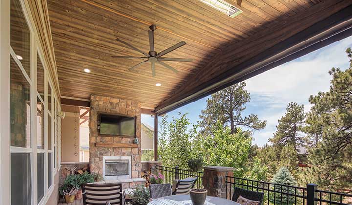 Long Colorado covered deck area with fireplace TV table chairs and UFP-Edge Thermally Modified Back Country wood cladding ceiling