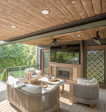 Beautiful Native Woods shiplap ceiling with couch and TV outdoor living area