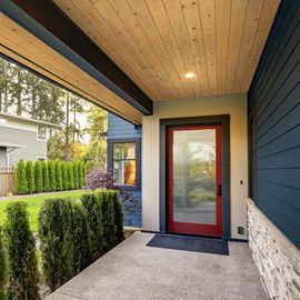 Front door outdoor entryway navy LP siding with Native Woods natural shiplap ceiling 