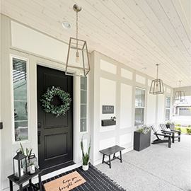 Black and white front porch entryway white home home rug Native Woods shiplap Alpine ceiling 