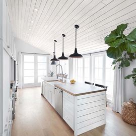 Modern kitchen with white rustic shiplap ceiling and island