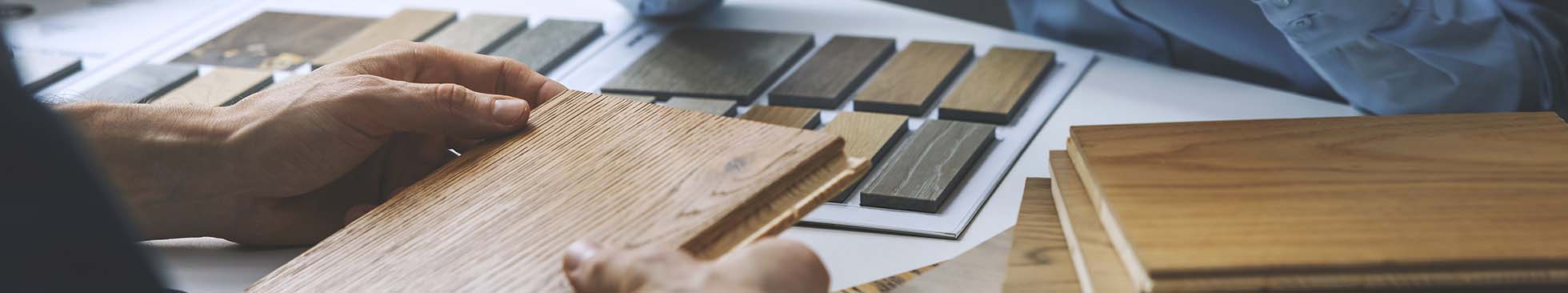 Architect holding wood sample with table displaying other color swatches